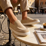 Beige suede slip-on loafers with tan panel detail and low white rubber sole