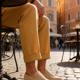 Beige suede loafers with classic low-profile design and stitched vamp detail