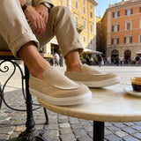 Beige suede loafers on feet, showing slip-on cut and low white platform sole