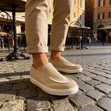 Beige suede loafers, angled side view with smooth vamp and stitched edges
