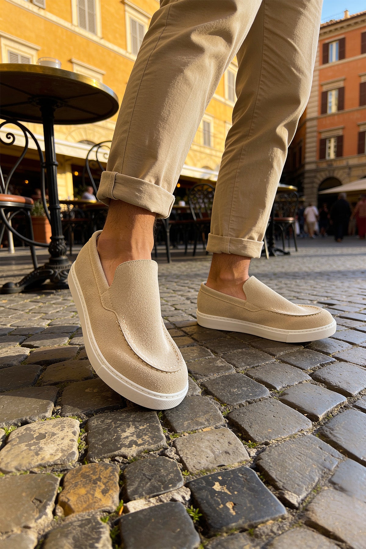 Beige suede slip-on loafers, close-up side view with low white sole