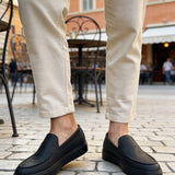 Men's black slip-on loafers, side profile with low stacked heel