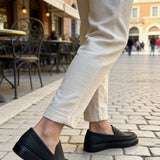 Men's black slip-on loafers, front angle with visible seam detail