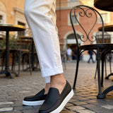 Black slip-on loafers with white rubber sole, casual men's shoes