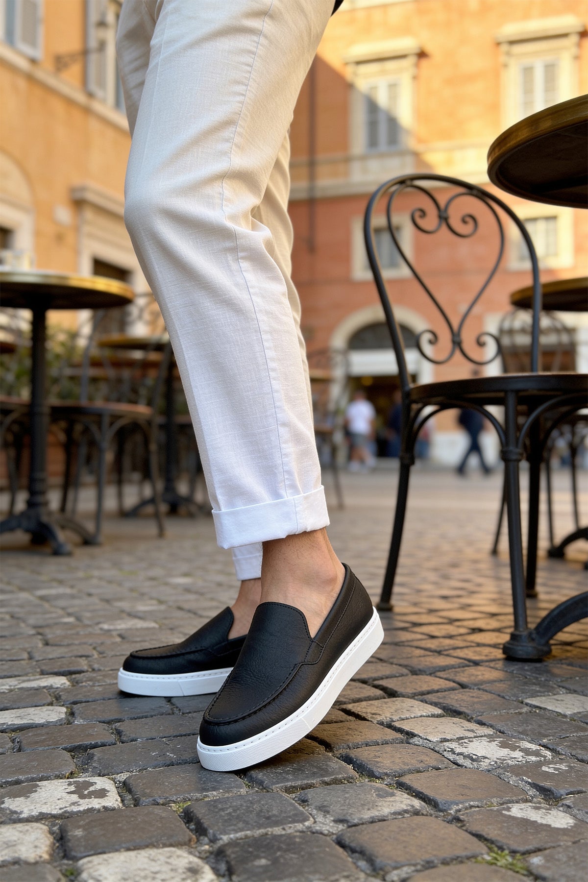 Black slip-on loafers with white rubber sole, casual men's shoes