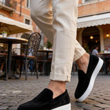 Black suede loafers with white rubber sole, low profile slip-on