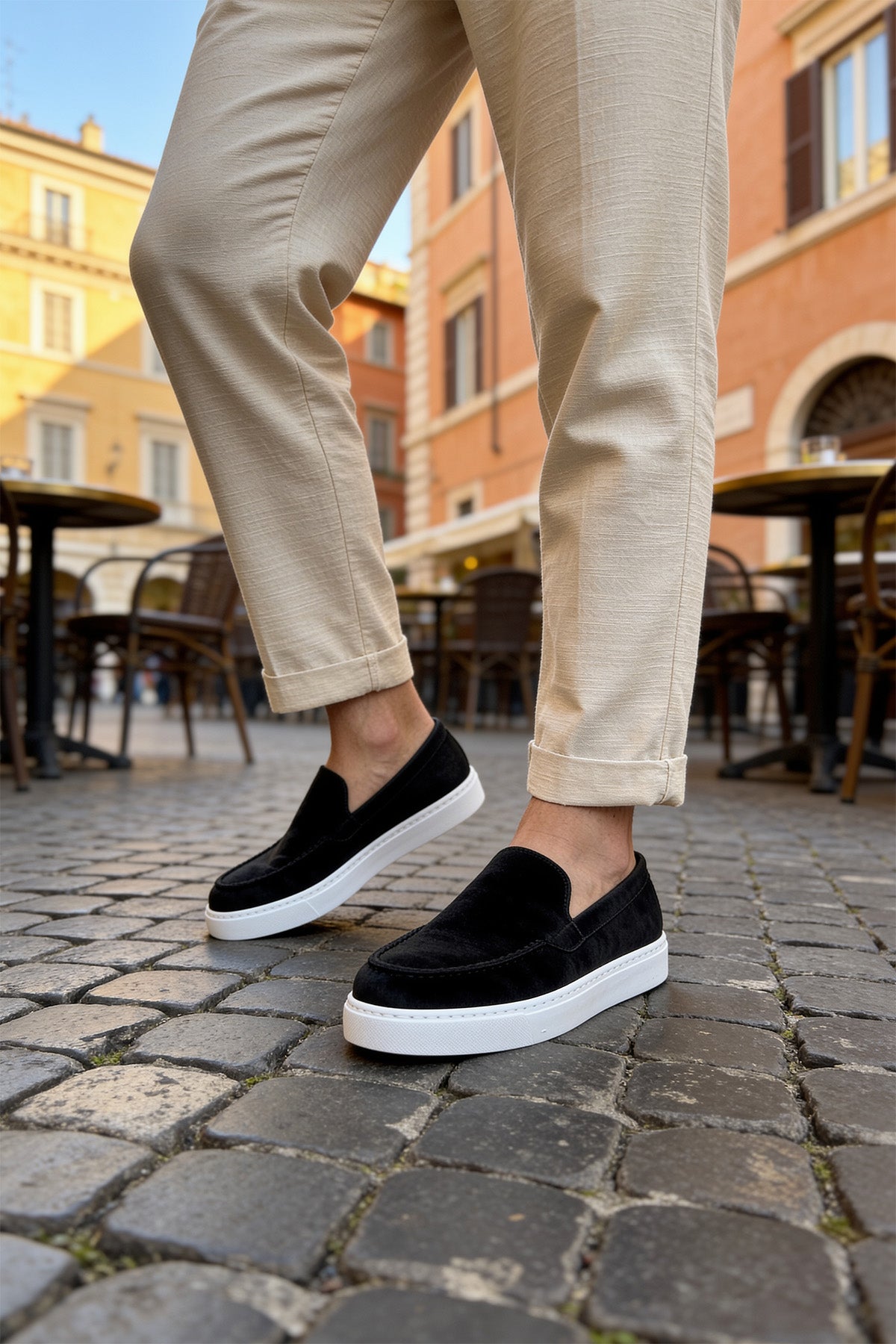 Black suede slip-on loafers with white sole and simple top seam