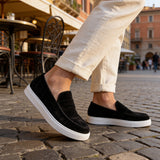 Black suede loafers, white rubber outsole, clean slip-on upper