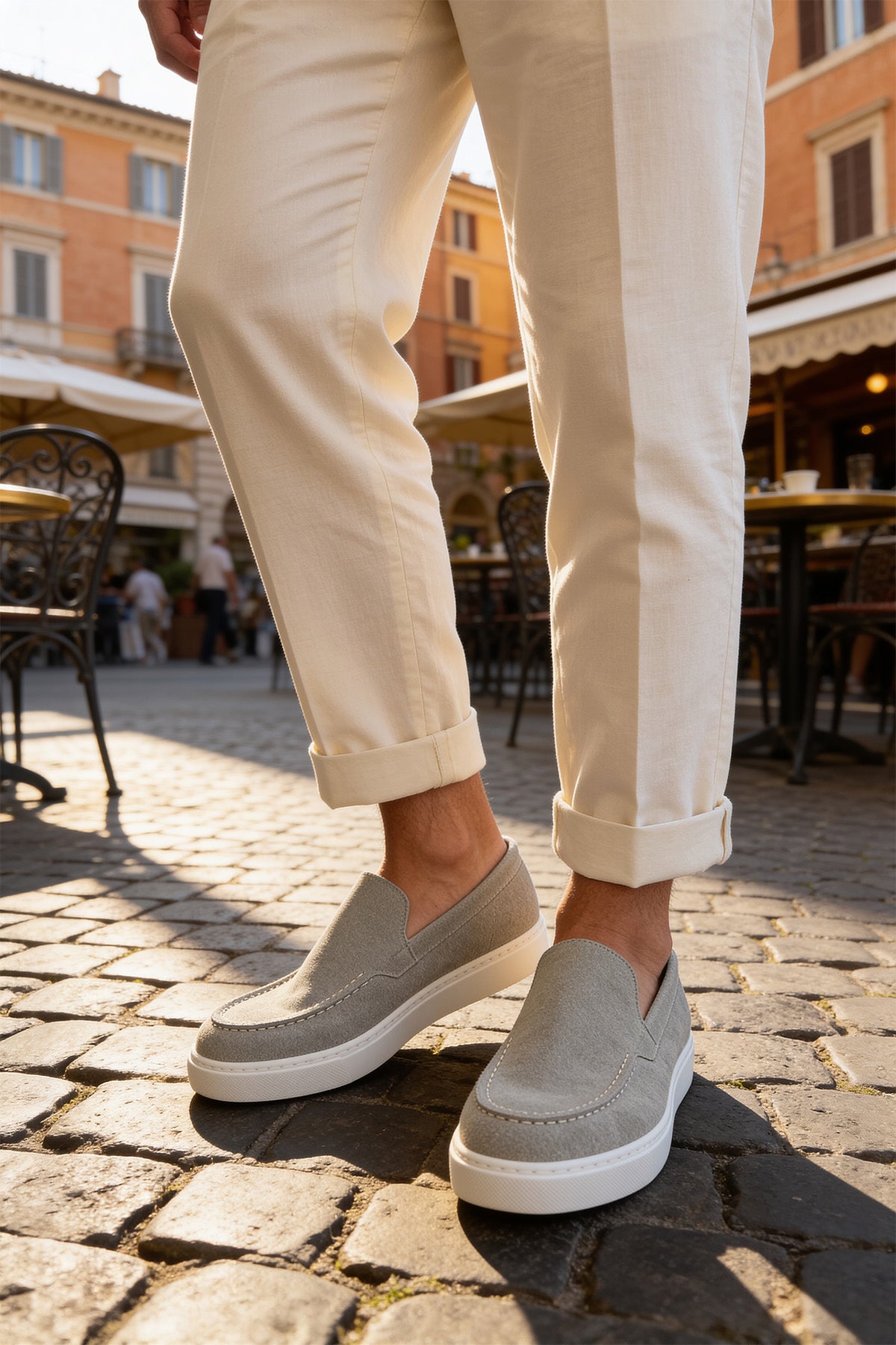Men's gray suede loafers, slip-on design with stitched apron and white rubber sole