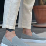 Men's gray suede loafers, slip-on design with white rubber sole and stitched vamp