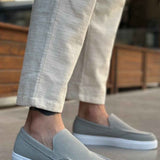 Men's gray suede loafers with stitched moc toe and white rubber sole