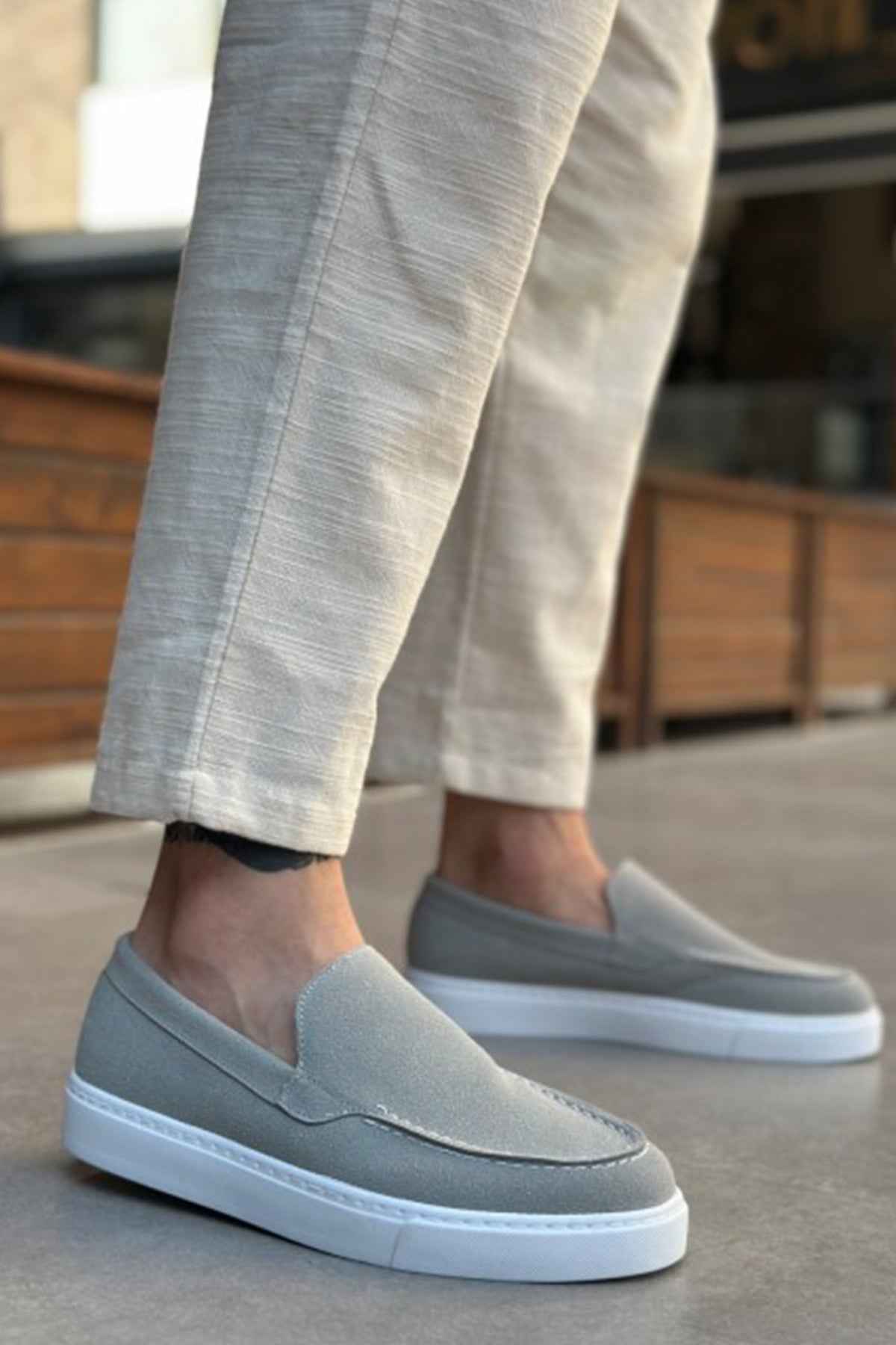 Men's gray suede loafers with stitched moc toe and white rubber sole