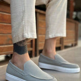Men's gray suede loafers with smooth vamp, slip-on fit, and white rubber sole