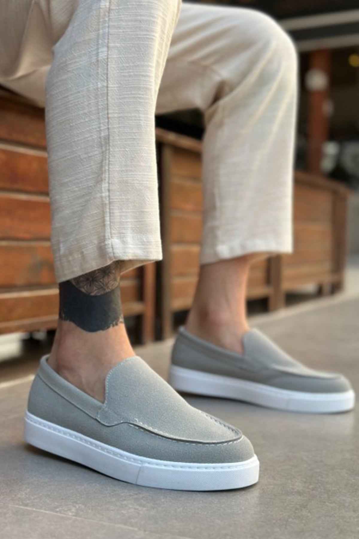 Men's gray suede loafers with smooth vamp, slip-on fit, and white rubber sole