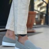 Men's gray suede loafers with moc-toe stitching and white rubber slip sole