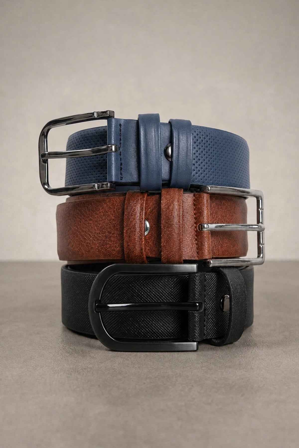 Men's 3-pack casual belts stacked with metal buckles in brown, black and blue