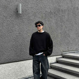 Dark charcoal baggy jeans with relaxed straight leg and cuffed hems, five pockets