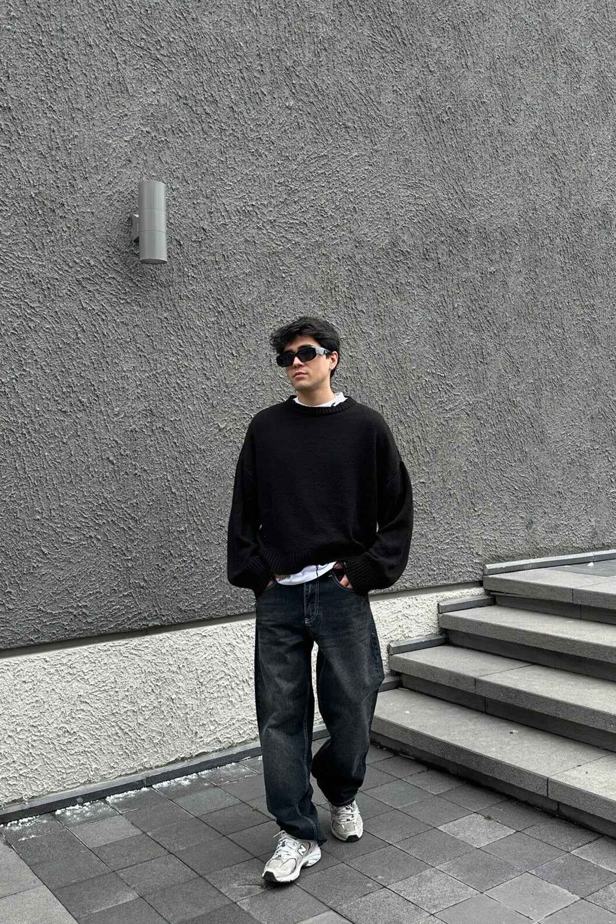 Dark charcoal baggy jeans with relaxed straight leg and cuffed hems, five pockets