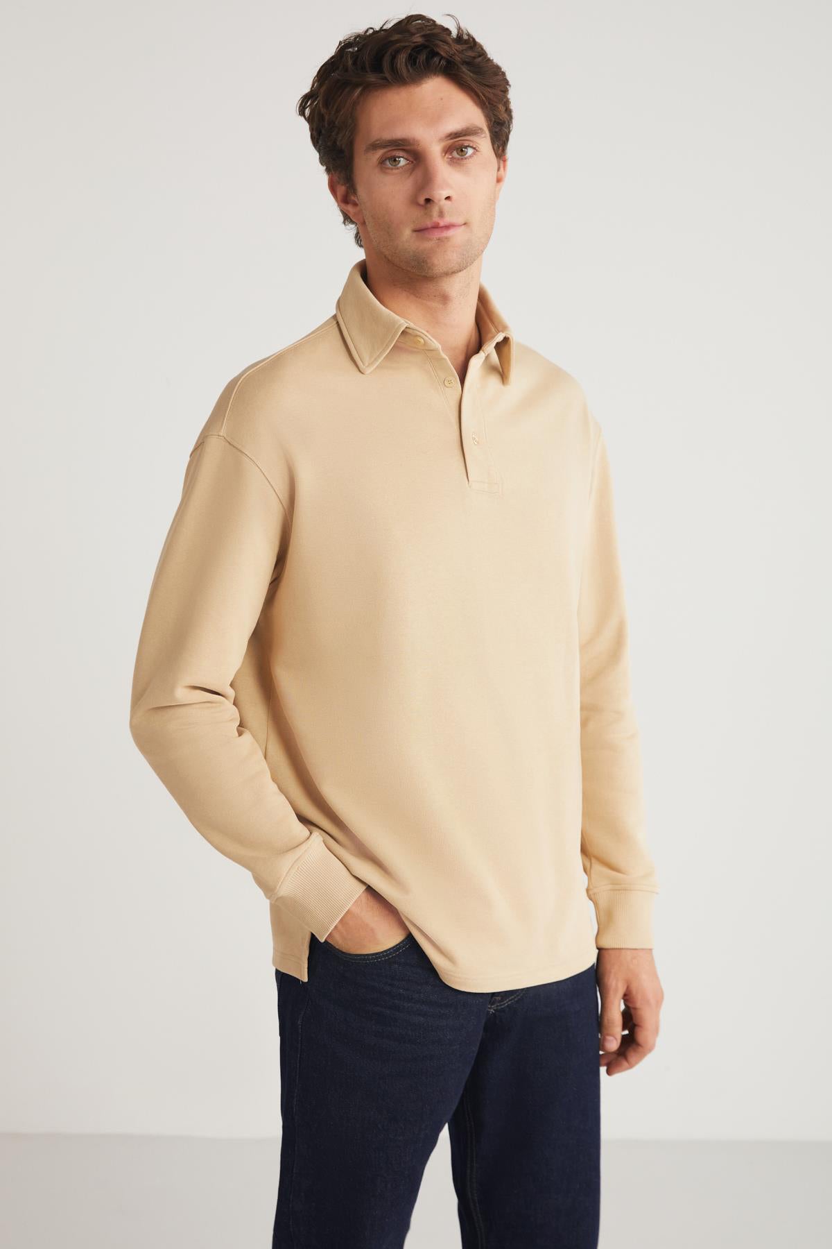 Men's beige relaxed-fit crewneck sweatshirt, close front-left view with crew neckline