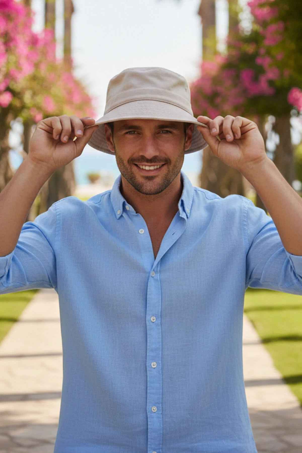 Beige bucket hat with wide brim, Ritar, held by a man in a blue shirt