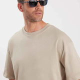 Oversize beige T-shirt crew neck and short sleeves, close-up