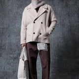 Men's oversized double-breasted coat in light beige with wide lapels and dark buttons