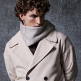 Men's oversized beige coat close-up: wide lapels, double-breasted buttons, front pockets