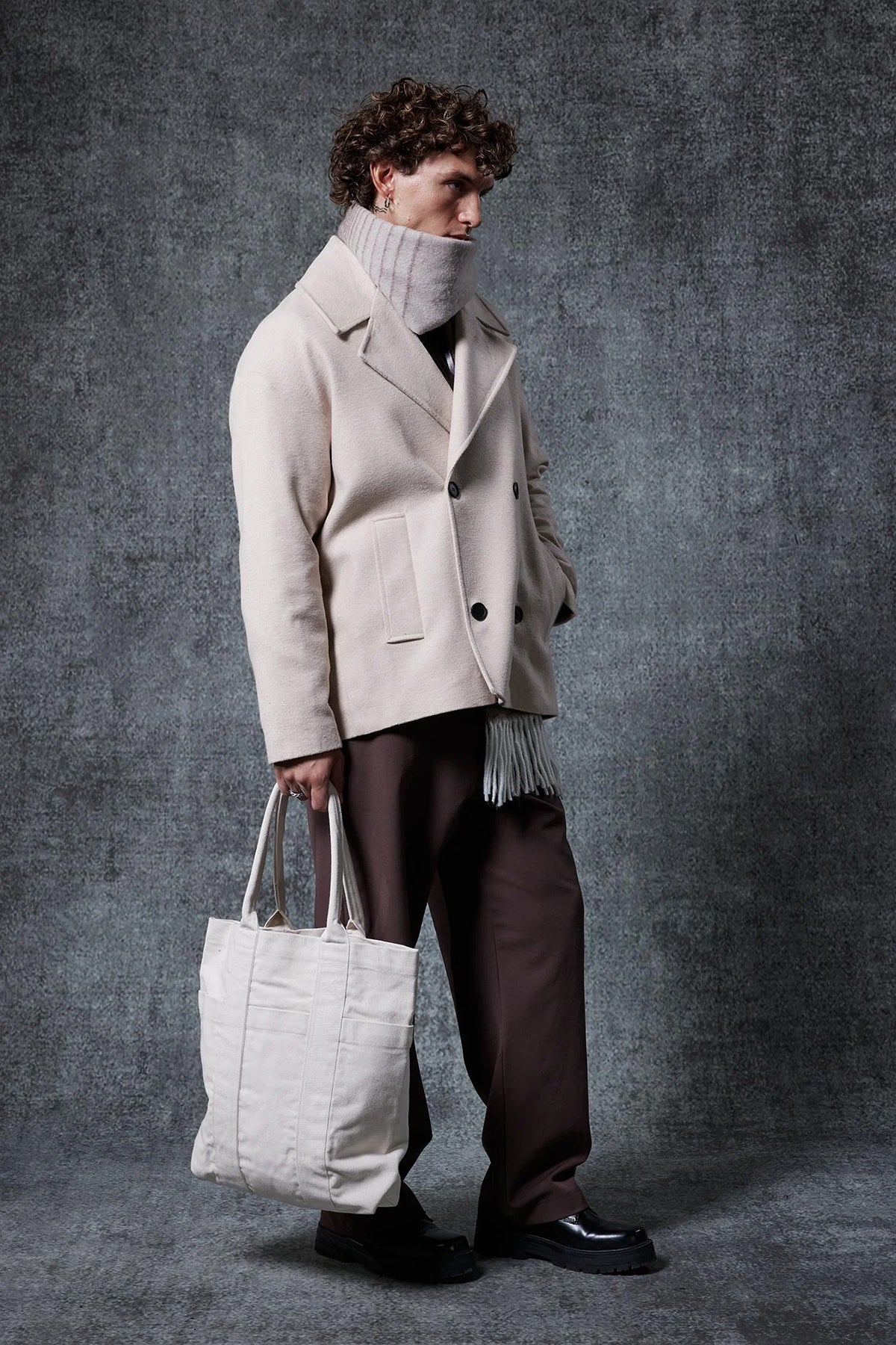 Men's oversized light beige double-breasted coat with wide lapels and patch pockets
