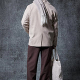 Men's oversized light beige coat, back view with center seam and standing collar