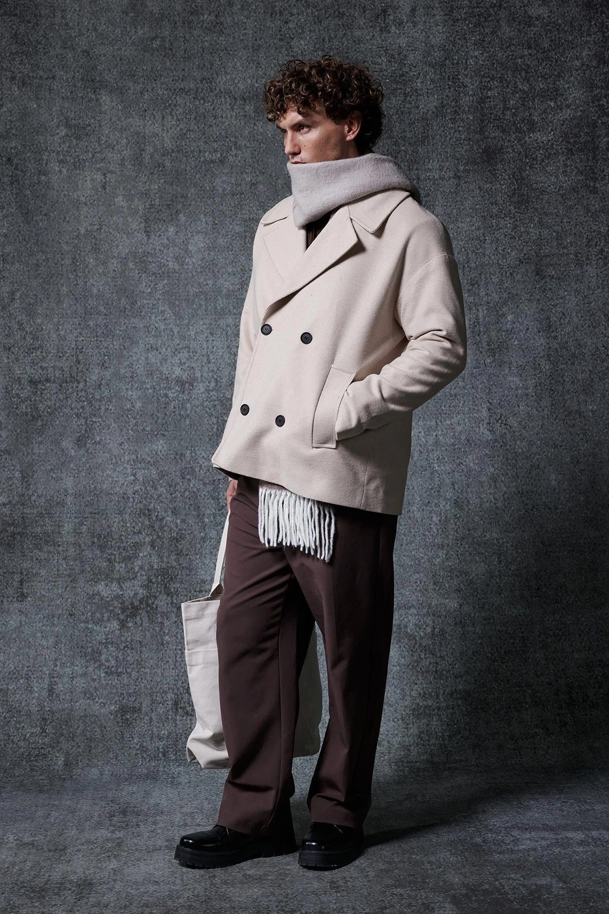 Men's oversized light beige double-breasted coat with wide lapels and front buttoning