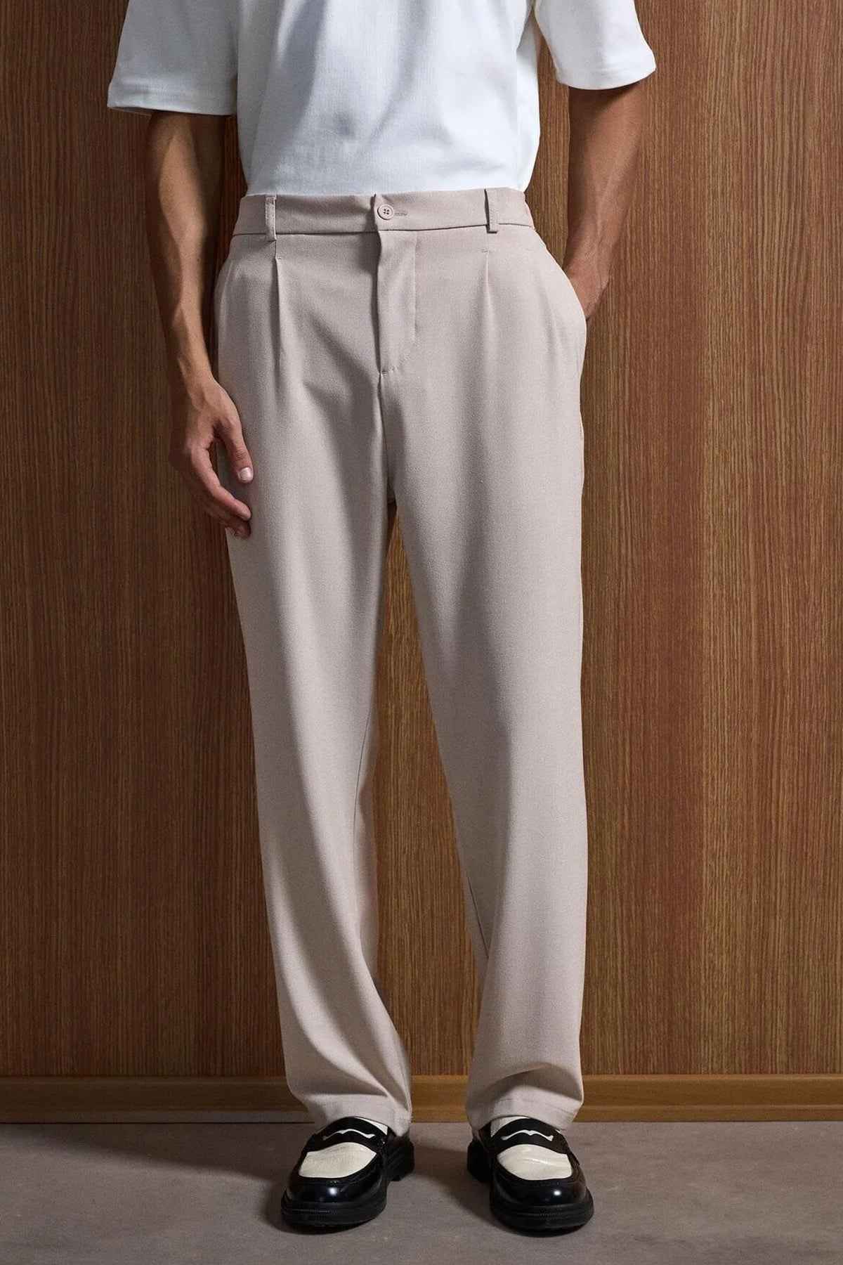 Beige oversized suit trousers with belt loops and straight-leg fit