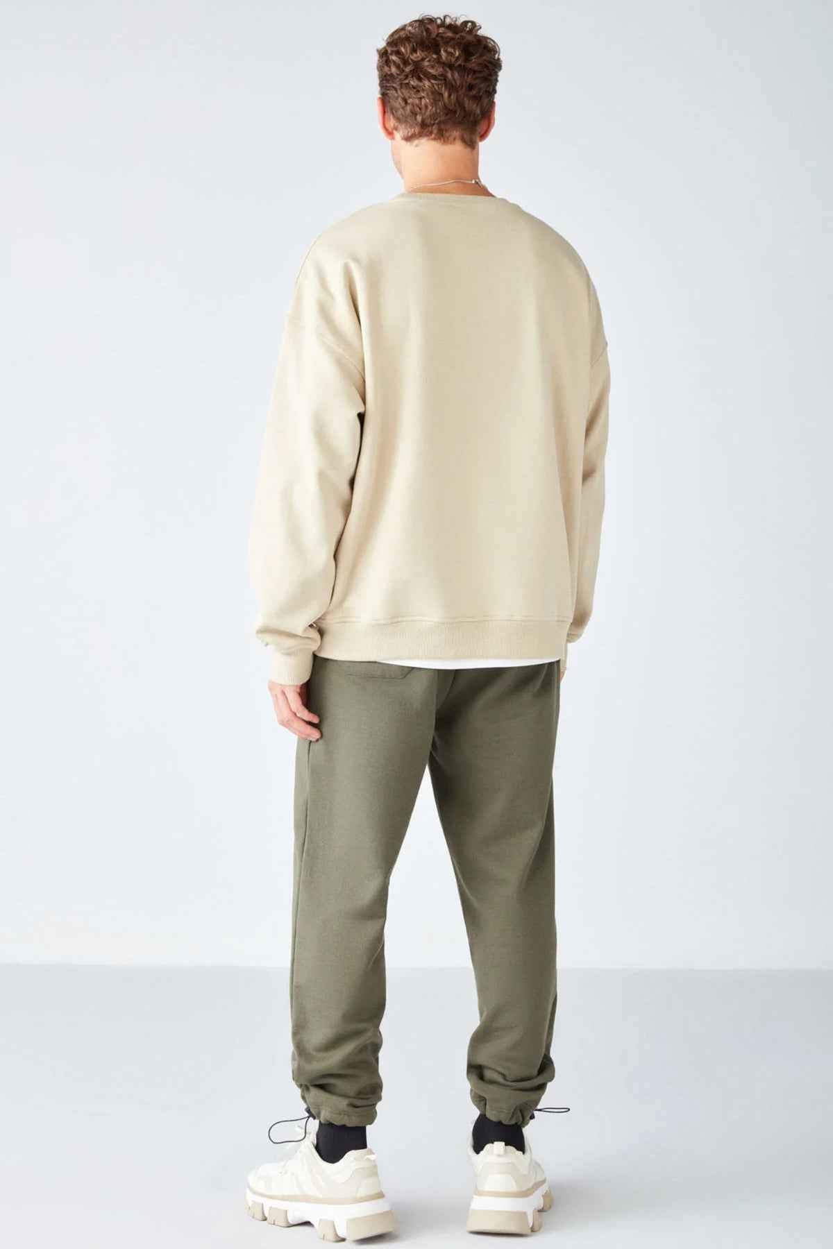 Men's beige oversized sweatshirt back view with crew neck; ribbed cuffs and hem, Stephan
