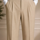 Beige dress pants with pleated front and black belt with buckle
