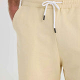 Men's light beige shorts close-up: elastic waistband and white drawstring