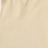 Men's light beige shorts fabric close-up with stitched seam details