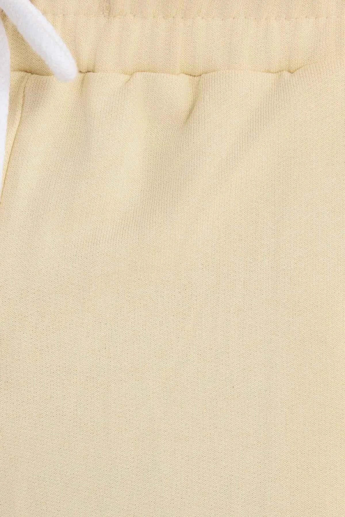 Men's light beige shorts fabric close-up with stitched seam details