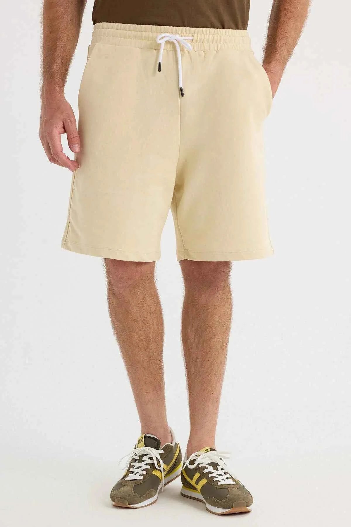 Men's light beige shorts front view with drawstring waist and side pockets
