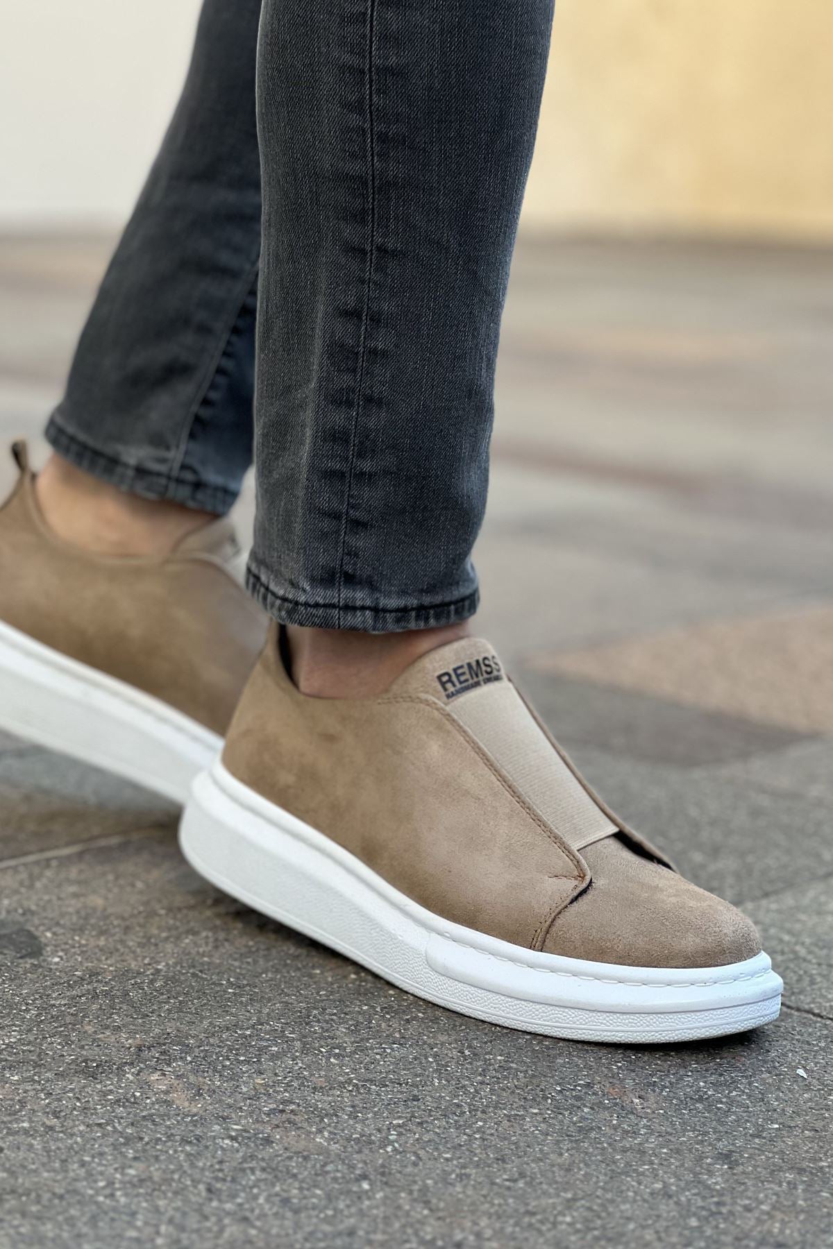 Beige low-top slip-on sneakers with white rubber sole, side view, pull tab