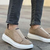 Pair of beige low-top slip-on sneakers with white rubber soles, side view