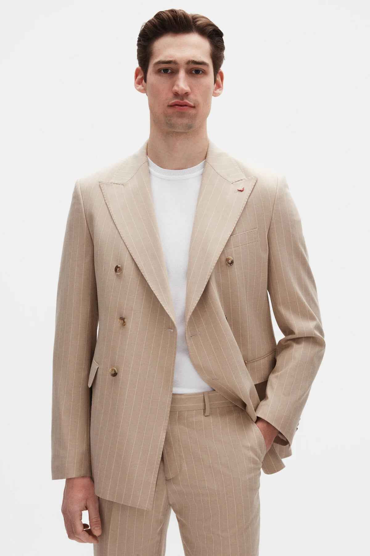 Beige striped men’s suit blazer with notch lapels and double-breasted button front.