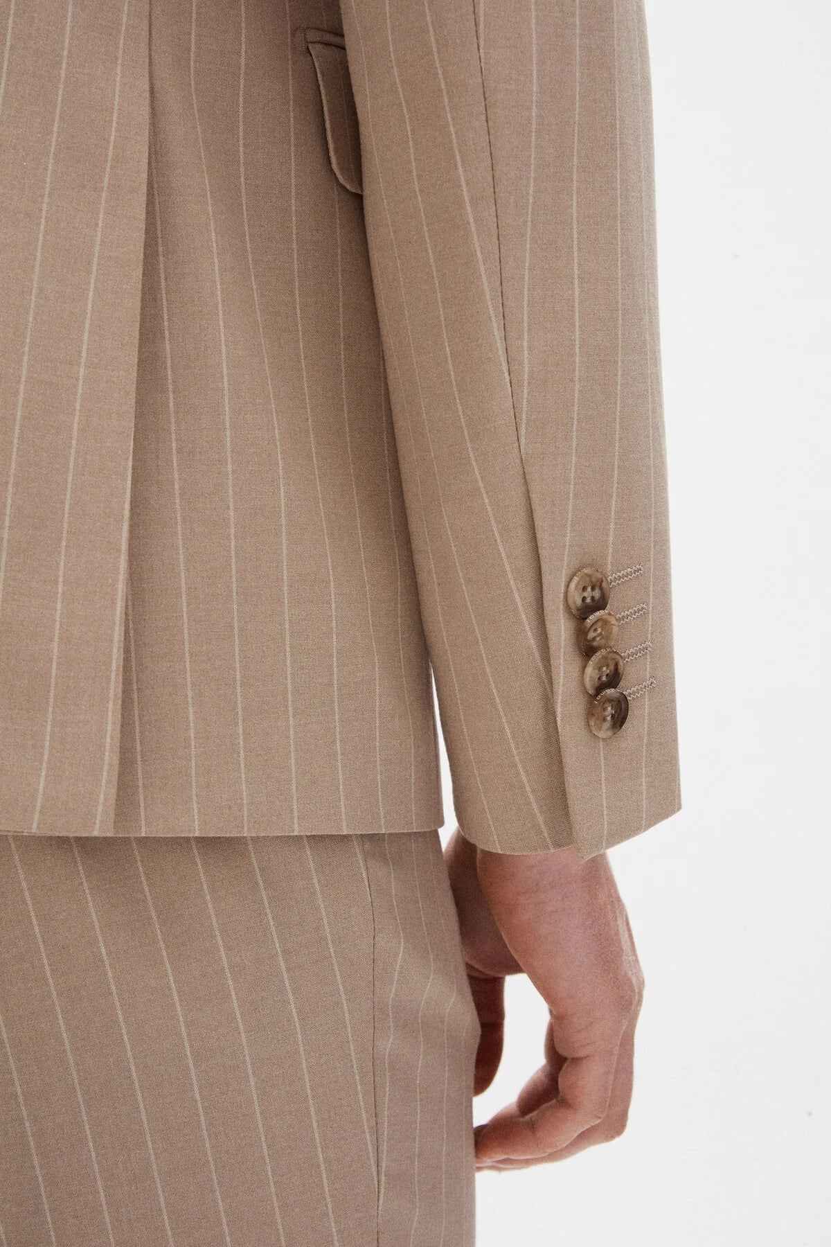 Beige striped men’s suit trousers with side seams and hem, button closure.