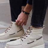 Beige suede lace-up boots with side pull tab and thick lug sole