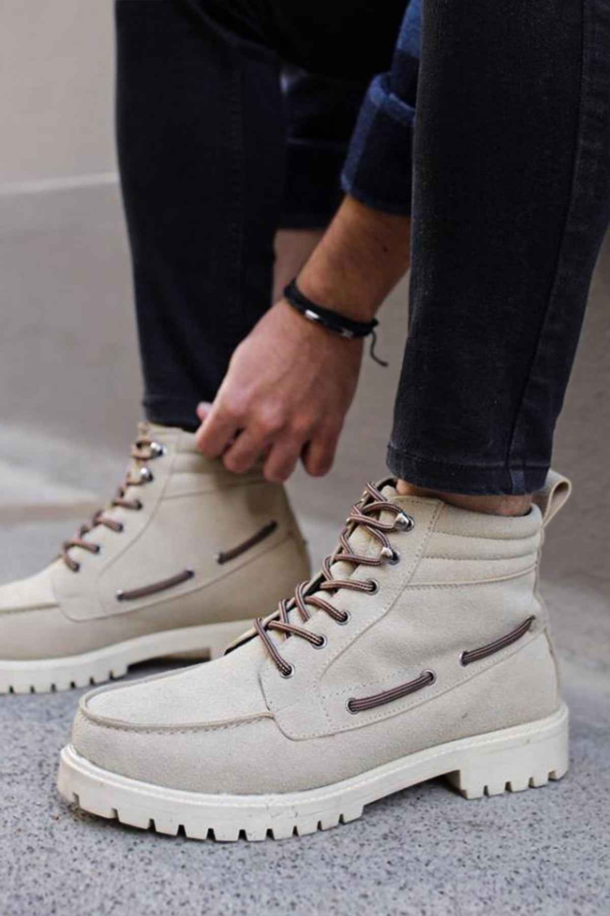 Beige suede lace-up boots with side pull tab and thick lug sole