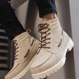 Beige suede men’s lace-up boots with rugged white sole and dark lace eyelets