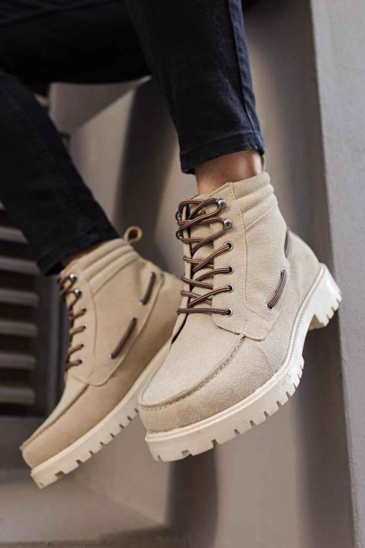 Beige suede men’s lace-up boots with rugged white sole and dark lace eyelets