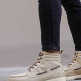 Beige suede lace-up boots with chunky tread sole and dark side stripe accents
