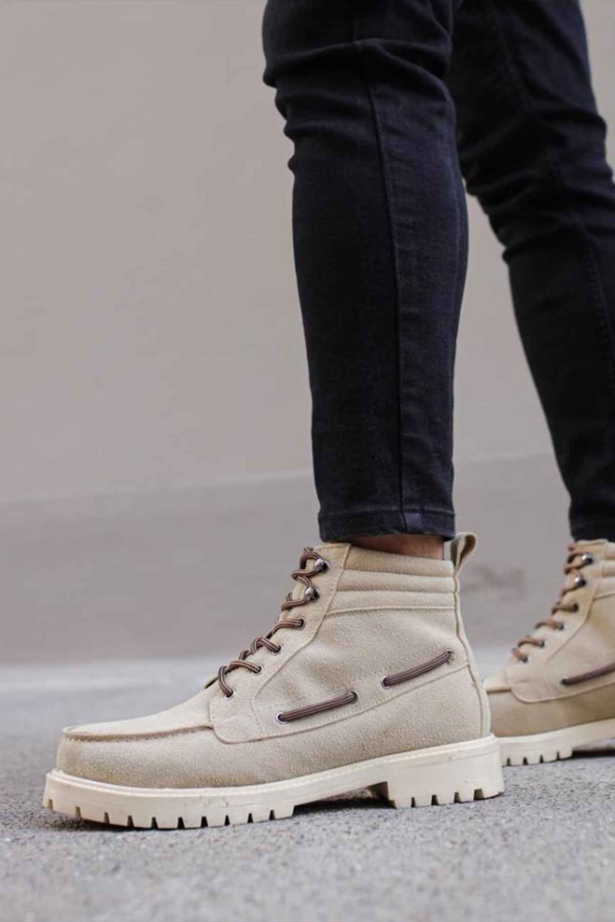 Beige suede lace-up boots with chunky tread sole and dark side stripe accents