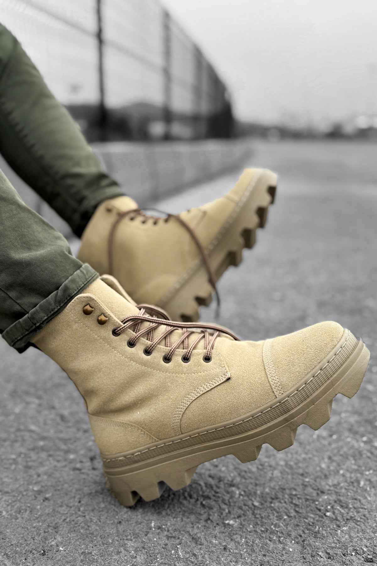 Men's beige suede lace-up boots, side view with textured lug outsole