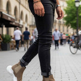 Men's beige suede ankle boots, white sole, worn with dark jeans