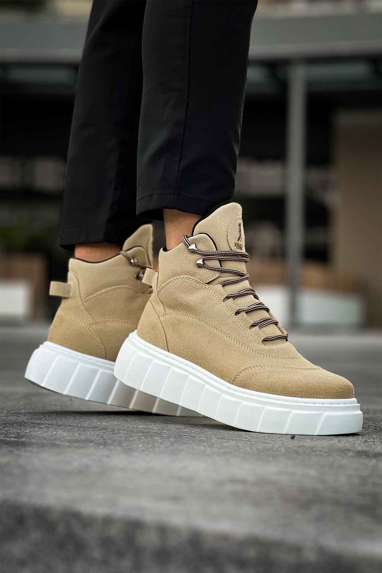 Beige suede lace-up boots with thick white platform sole and side profile